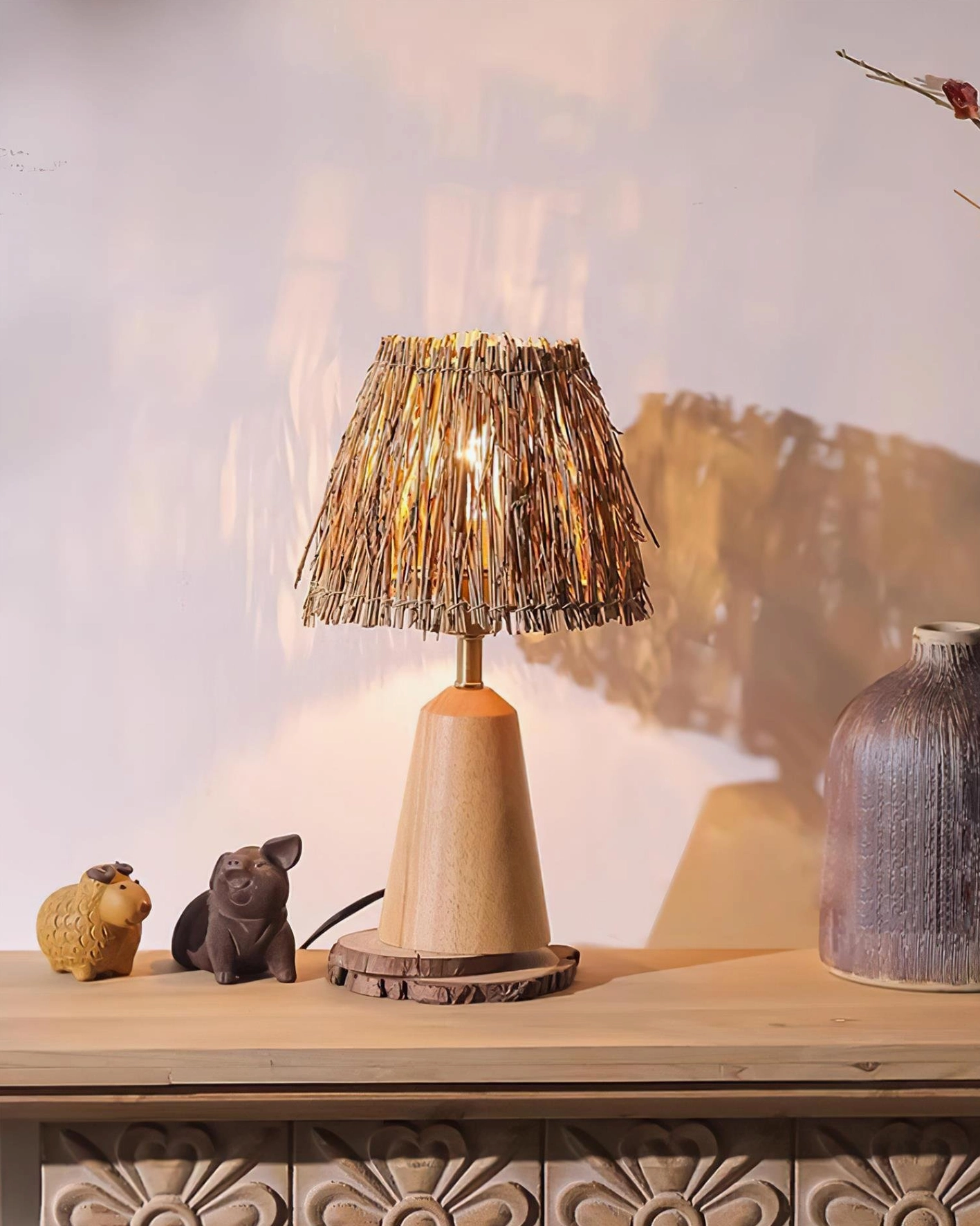 Light natural wood bohemian table lamp with woven straw shade and ornamental accents