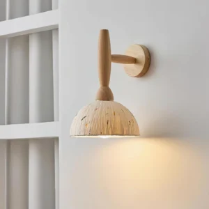 Playa natural light wood wall sconce with beige xuan paper shade mounted on white shelf, eye-level interior view