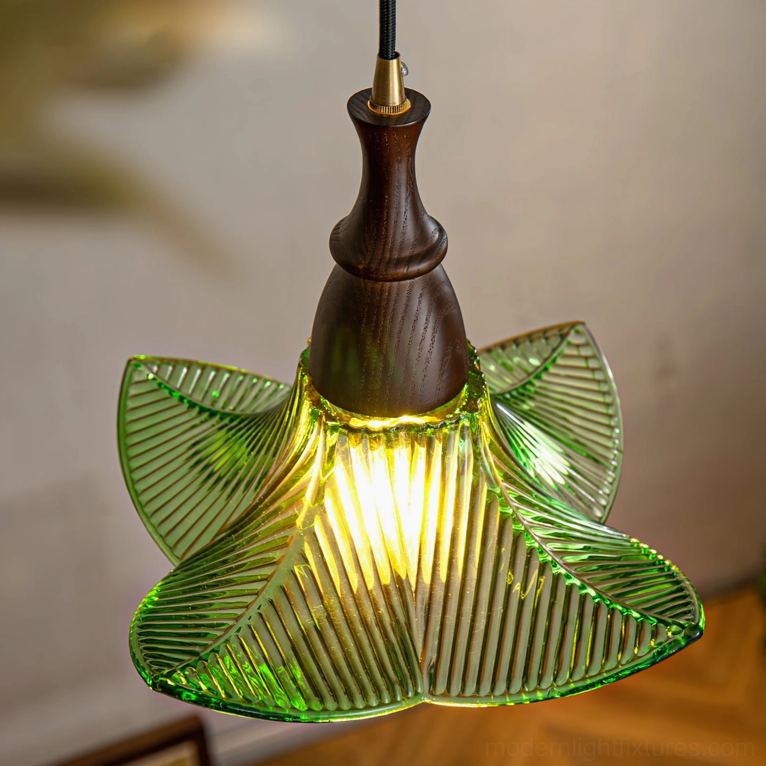 Close-up view of Lila pendant light showing detailed ribbed glass texture and illuminated warm bulb