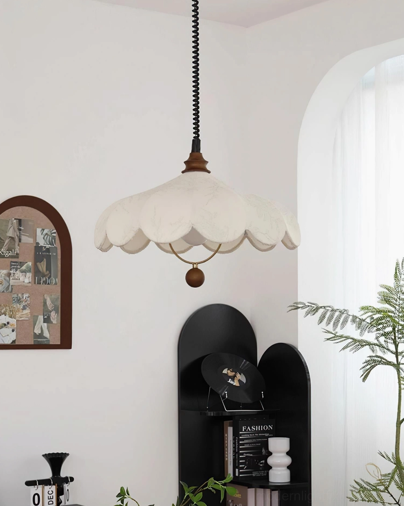 Modern pendant light in French style home corner, showing warm fabric shade and suspension cord
