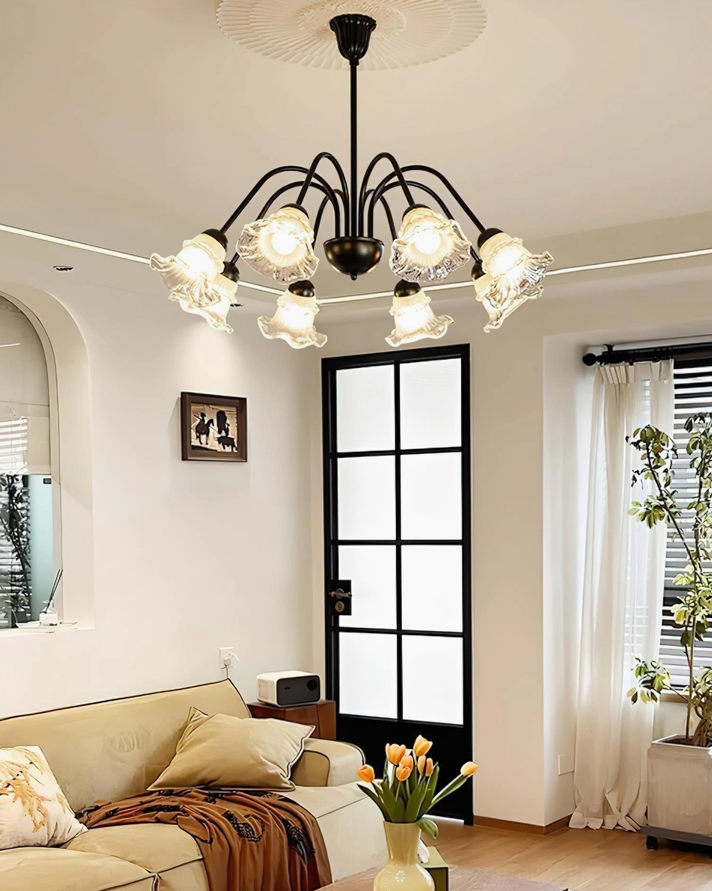 Contemporary flower chandelier with sculptural black metal frame and luminous glass shades