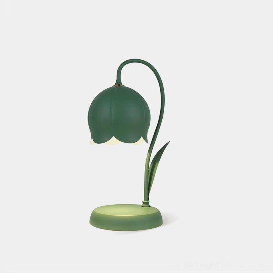 Lily flower candle warmer lamp in matte dark green metal, front studio view on plain background showing sculptural bell-shaped design