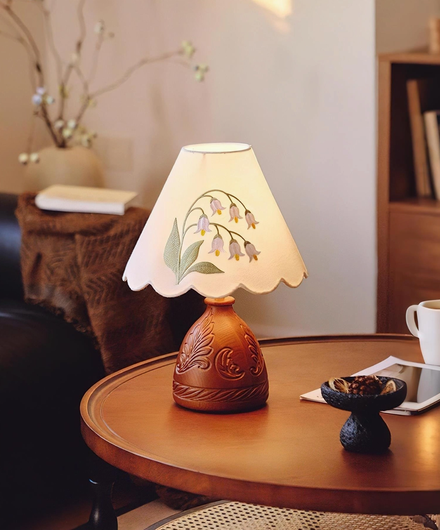 Botanical table lamp three-quarter side view showcasing embroidered shade and wood carving details