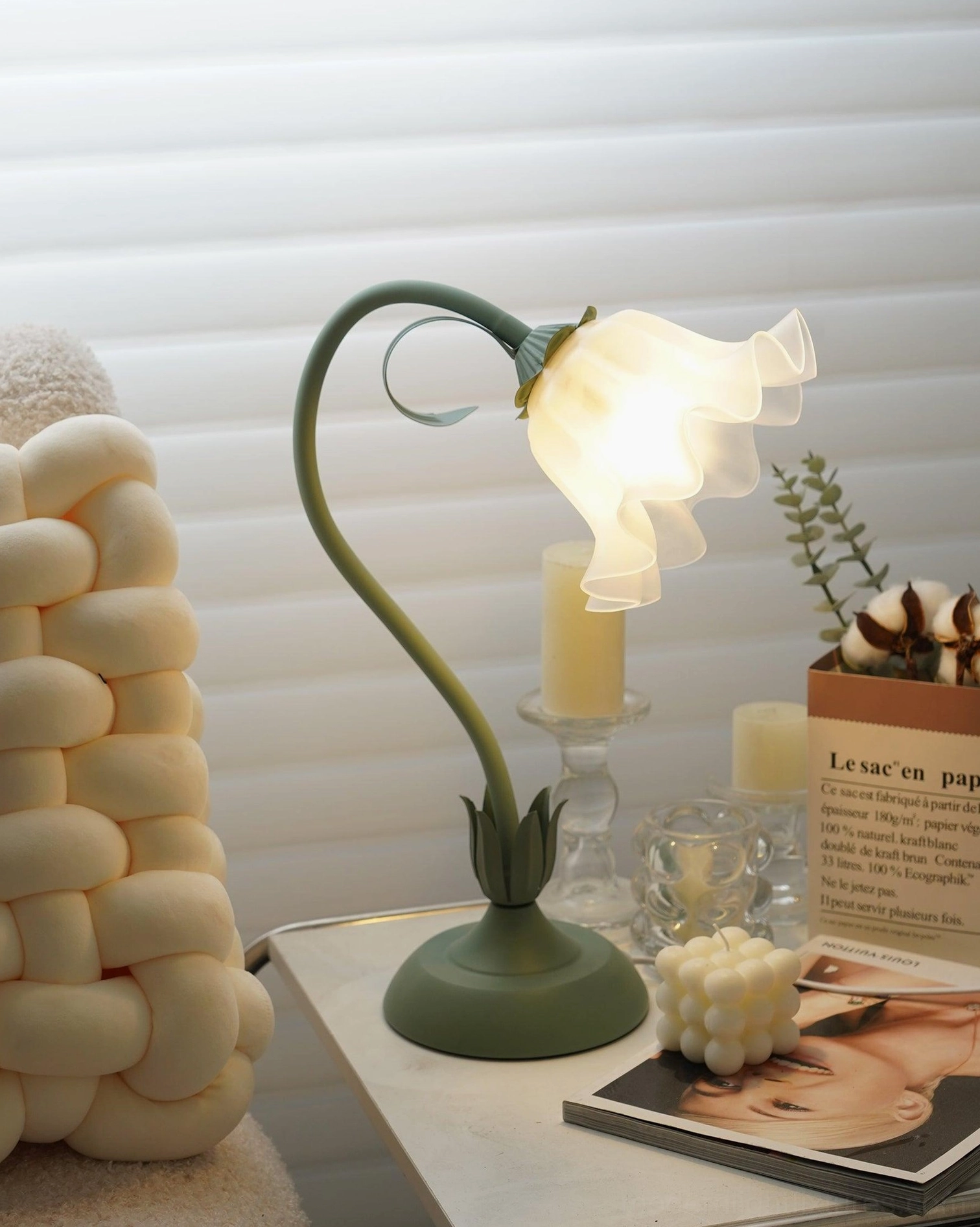 Lily flower table lamp three-quarter angle view showing curved metal arm and base structure