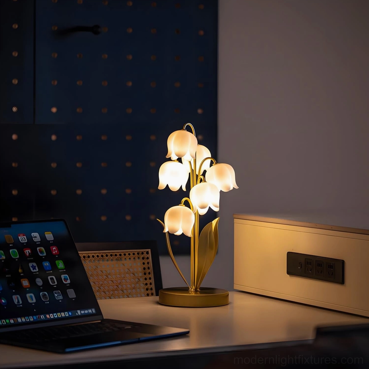 Modern table lamp with gold metal finish positioned on home office desk beside laptop for warm task lighting and contemporary workspace décor