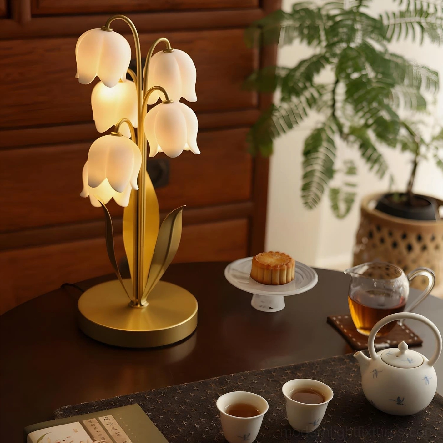 Lily of the valley table lamp with gold frame and white acrylic petal shades on tea table with desserts and tea set as matching home décor