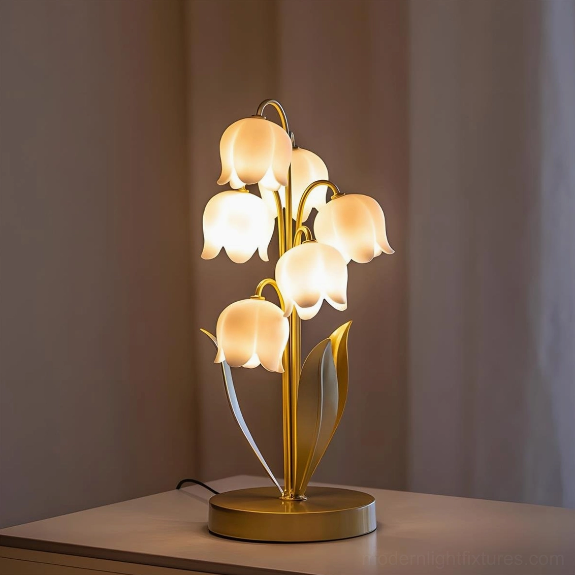 Lily of the valley table lamp in gold and white color variant with integrated LED warm light on display surface, modern botanical lighting fixture