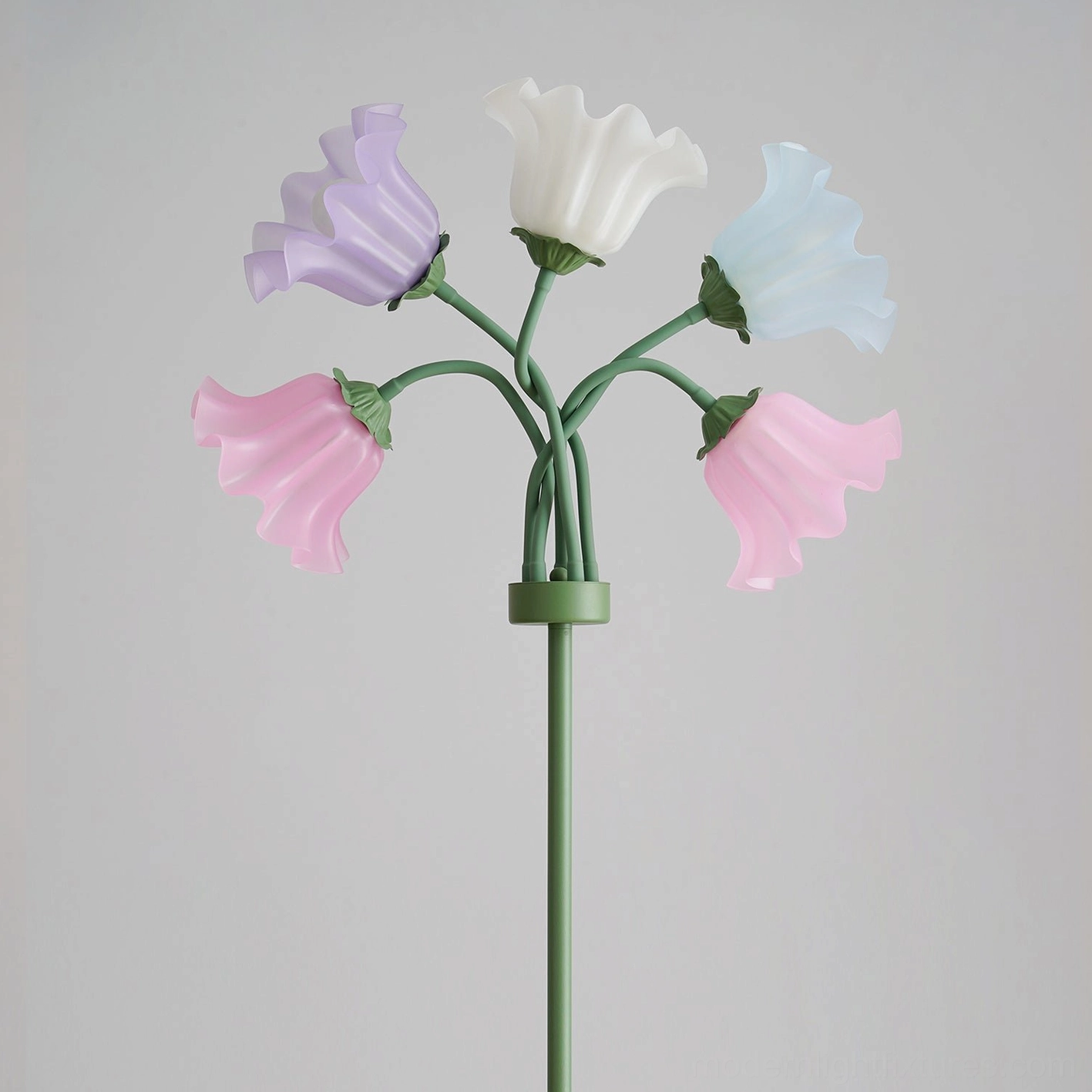 Unlit pastel lily of the valley floor lamp with green metal pole and assorted pastel flower shades on light gray background