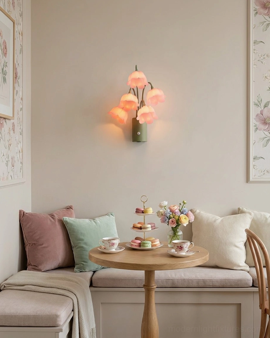 Lily-of-the-valley floral wall sconce collection showing three color options - cream, yellow, and pink - all with green iron stems and base