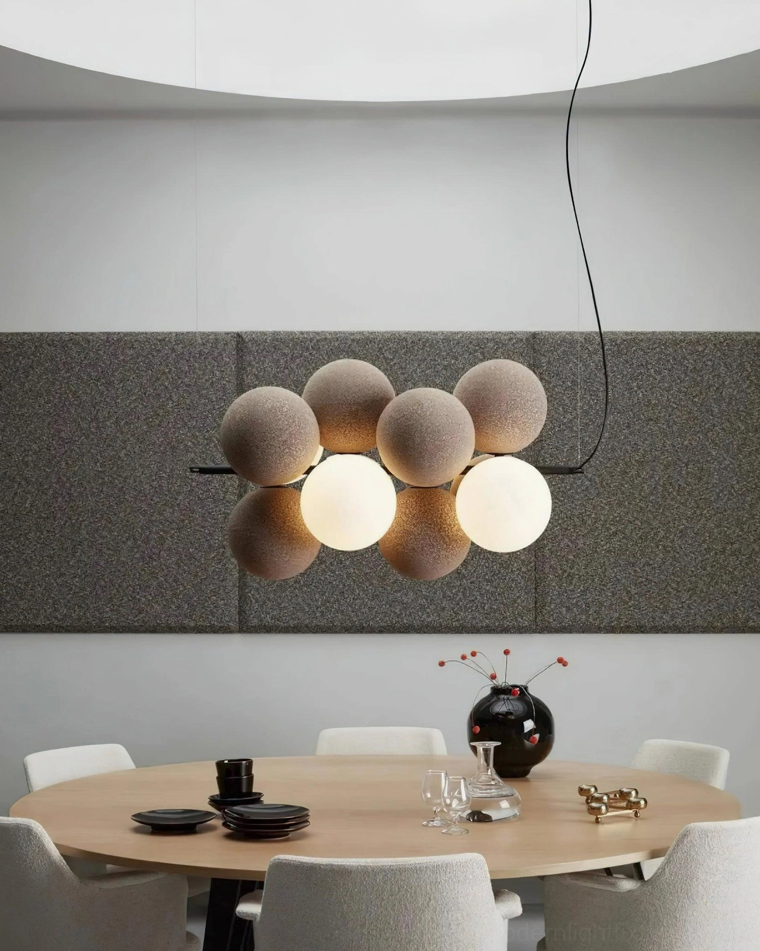 Overhead interior shot of horizontal linear bubble pendant light in modern dining room with matte brown off-white spheres