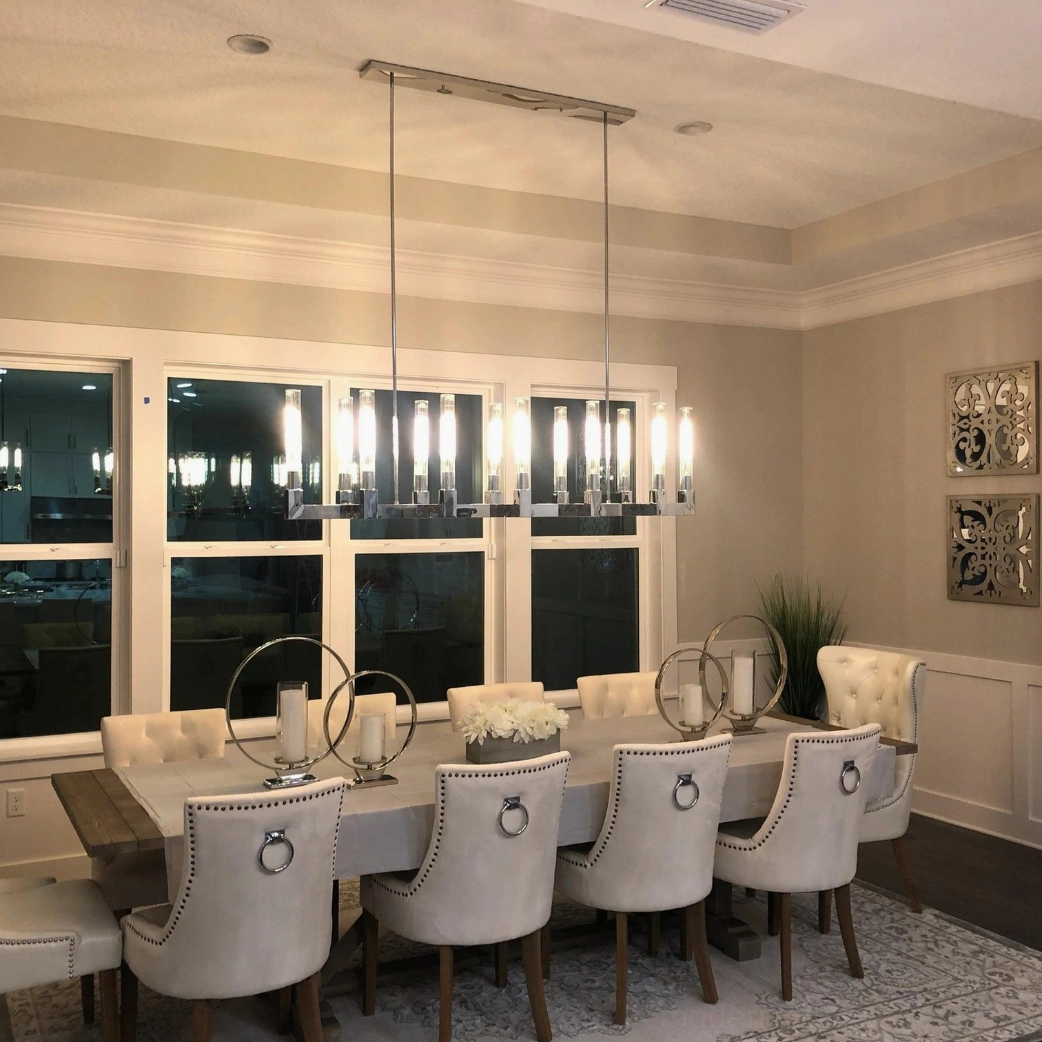 Linear brass glass chandelier open concept living space dining zone definition