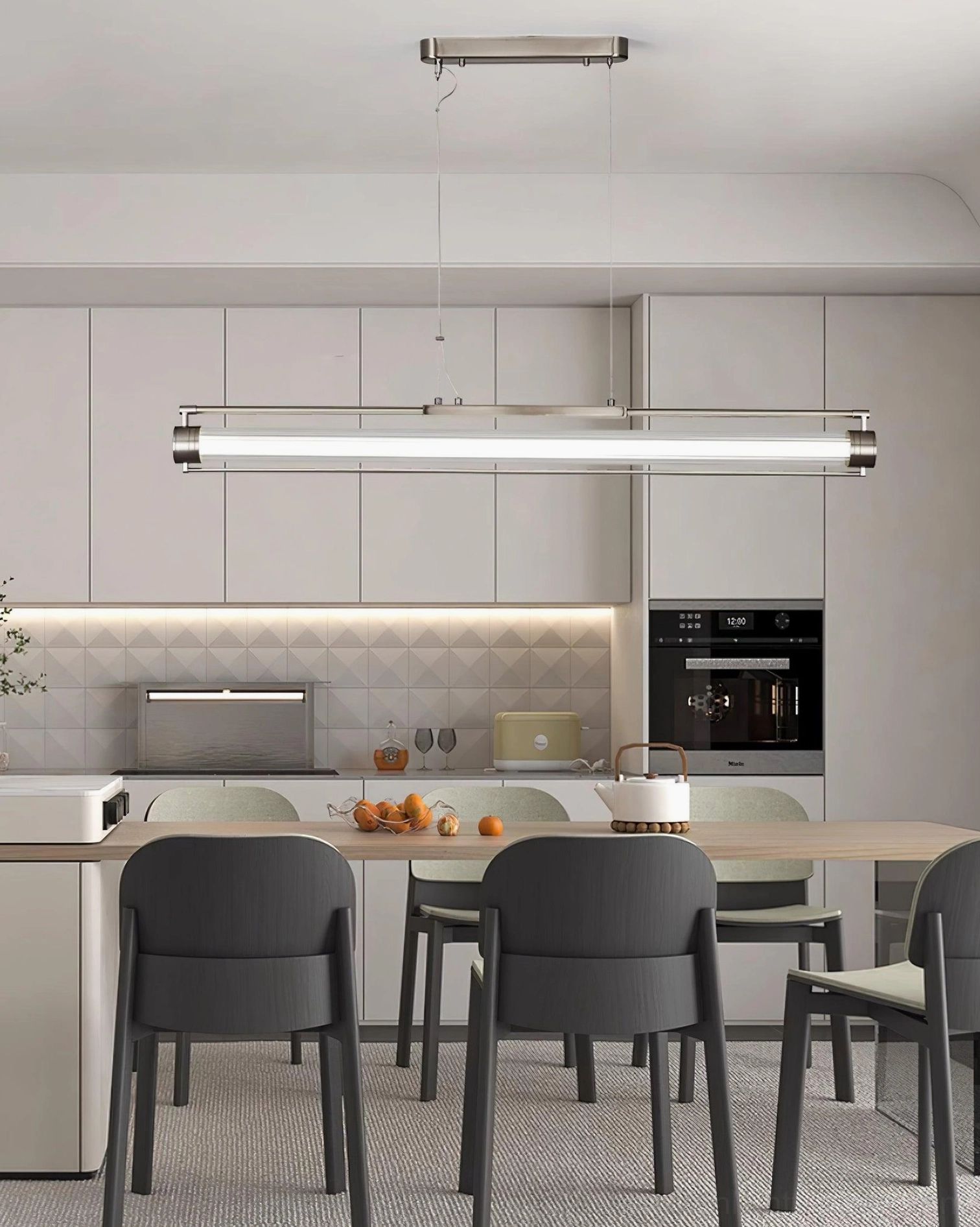 Modern linear LED pendant with cool white lighting above kitchen island - contemporary all-white cabinetry