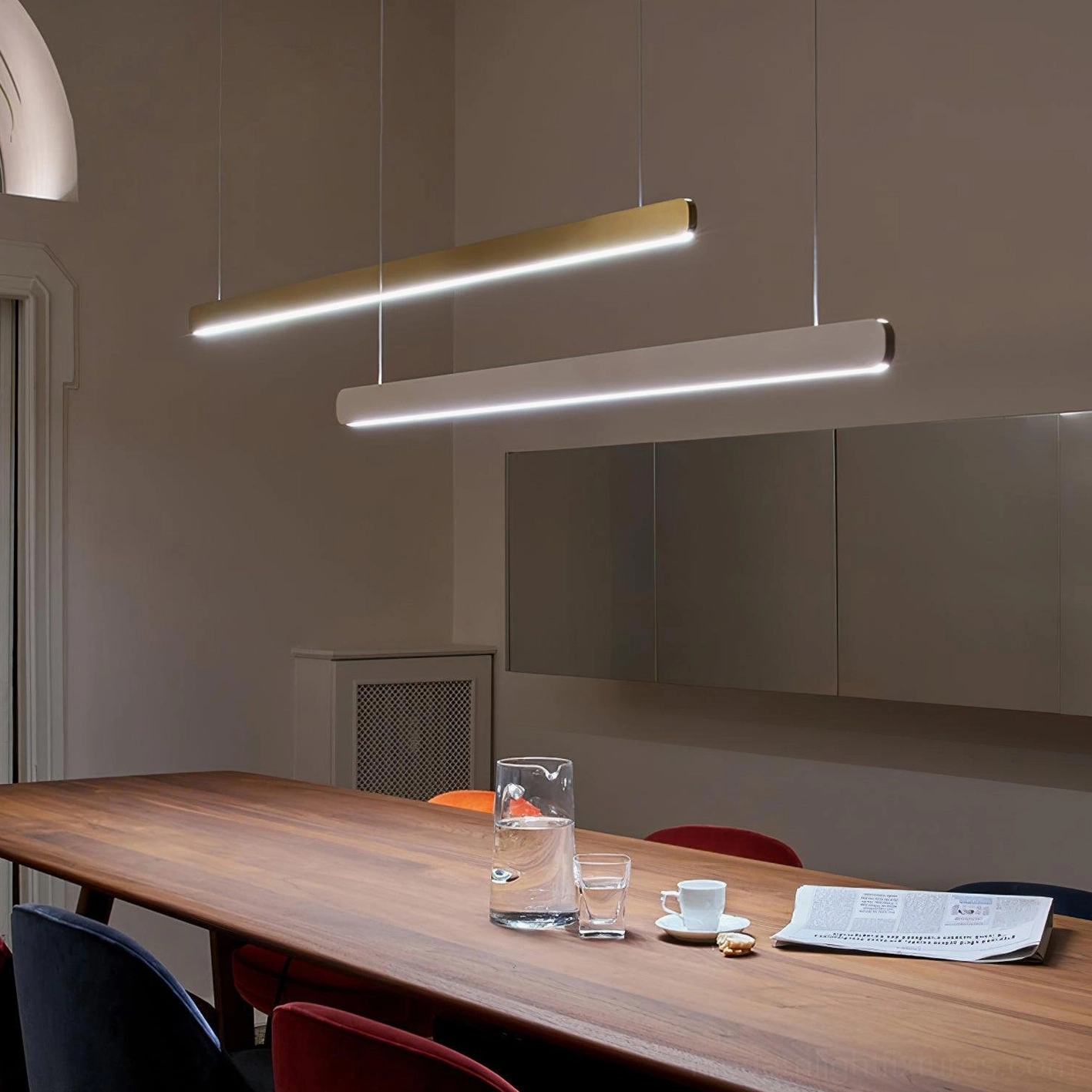 Contemporary linear LED pendant lamp creating focused task lighting above work surface