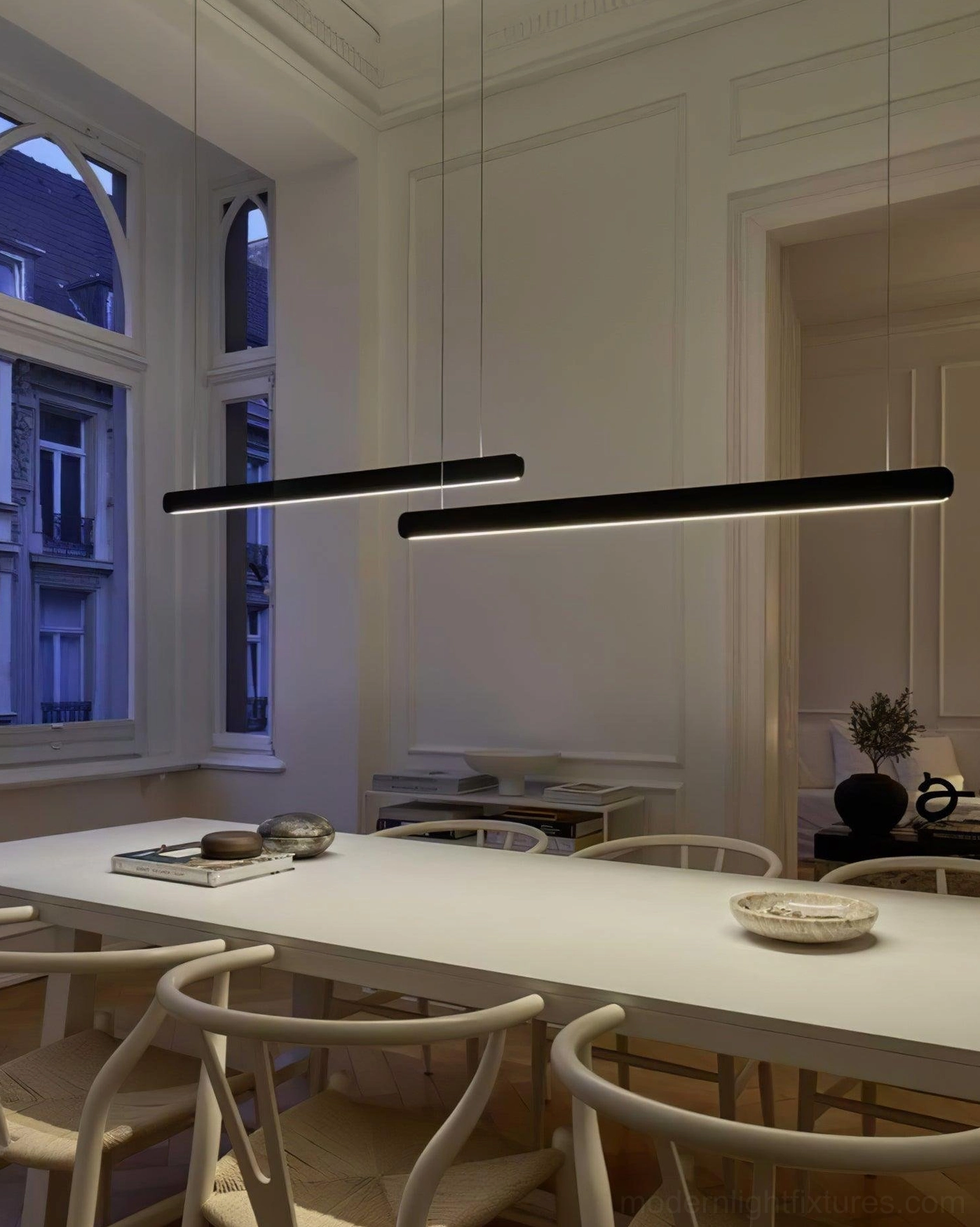 Dual linear pendant lamps creating ambient lighting in elegant European-style formal dining room
