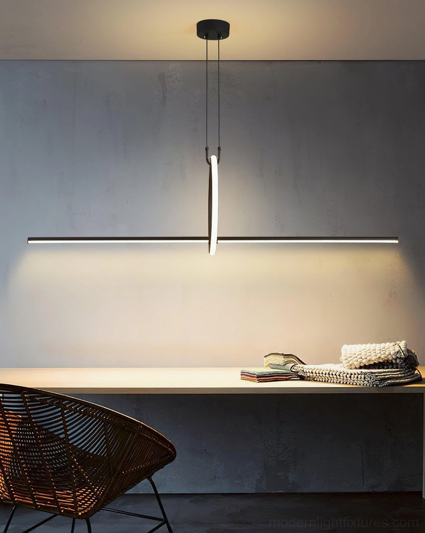 Contemporary linear pendant light creating warm ambient lighting in home office workspace with modern decor