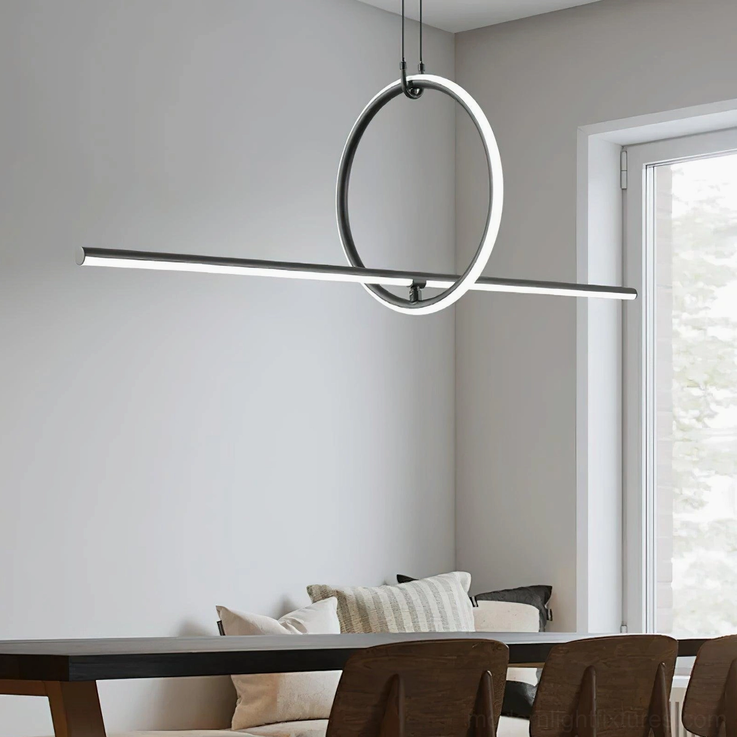 Linear ring pendant light suspended above dining table in Scandinavian minimalist dining room with warm ambient lighting
