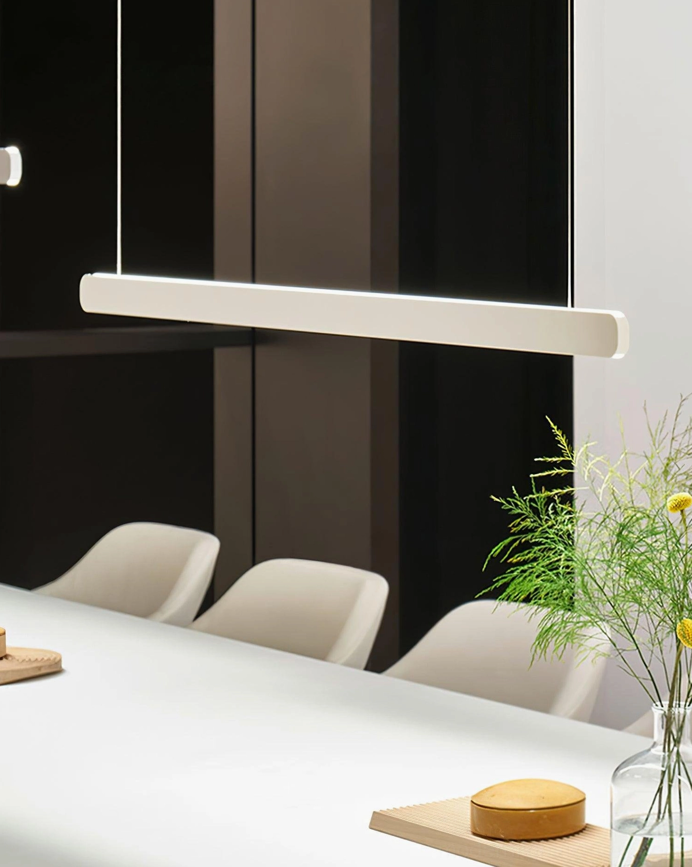 Modern linear pendant light fixture with warm color temperature in contemporary living space
