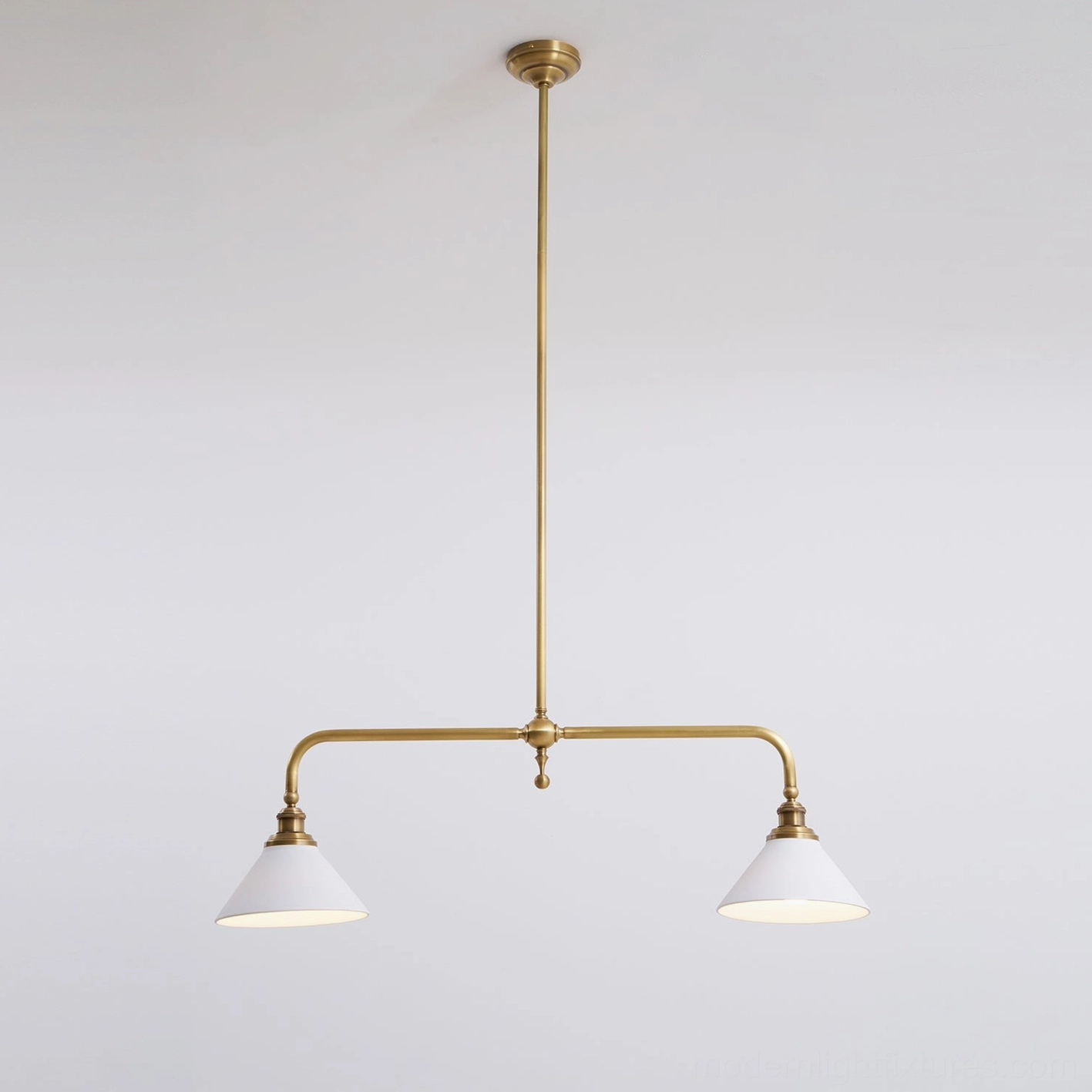 Linear pendant chandelier with opal ceramic shades and aged brass construction in contemporary home interior design