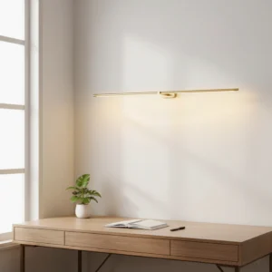 Modern linear wall sconce above wooden desk creating warm ambient lighting in home office workspace