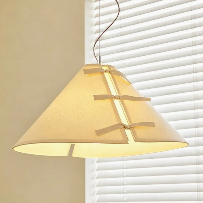 Linette Bow pendant light close-up showing fabric bow detail and cone shade texture, warm white LED glow