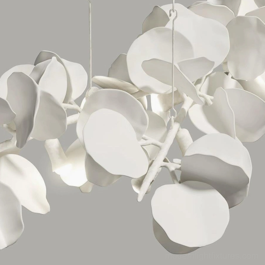 Liria Linear Chandelier suspended over dining table - modern sculptural leaf pendant creating ambient warm light