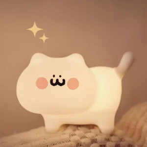 Illuminated cat night light emitting warm soft glow against cozy knitted textile backdrop, eye-level home setting