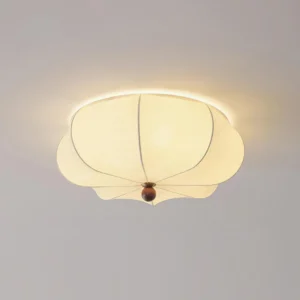 Illuminated organic petal ceiling fixture showing warm ambient glow and fabric texture, low-angle overhead perspective