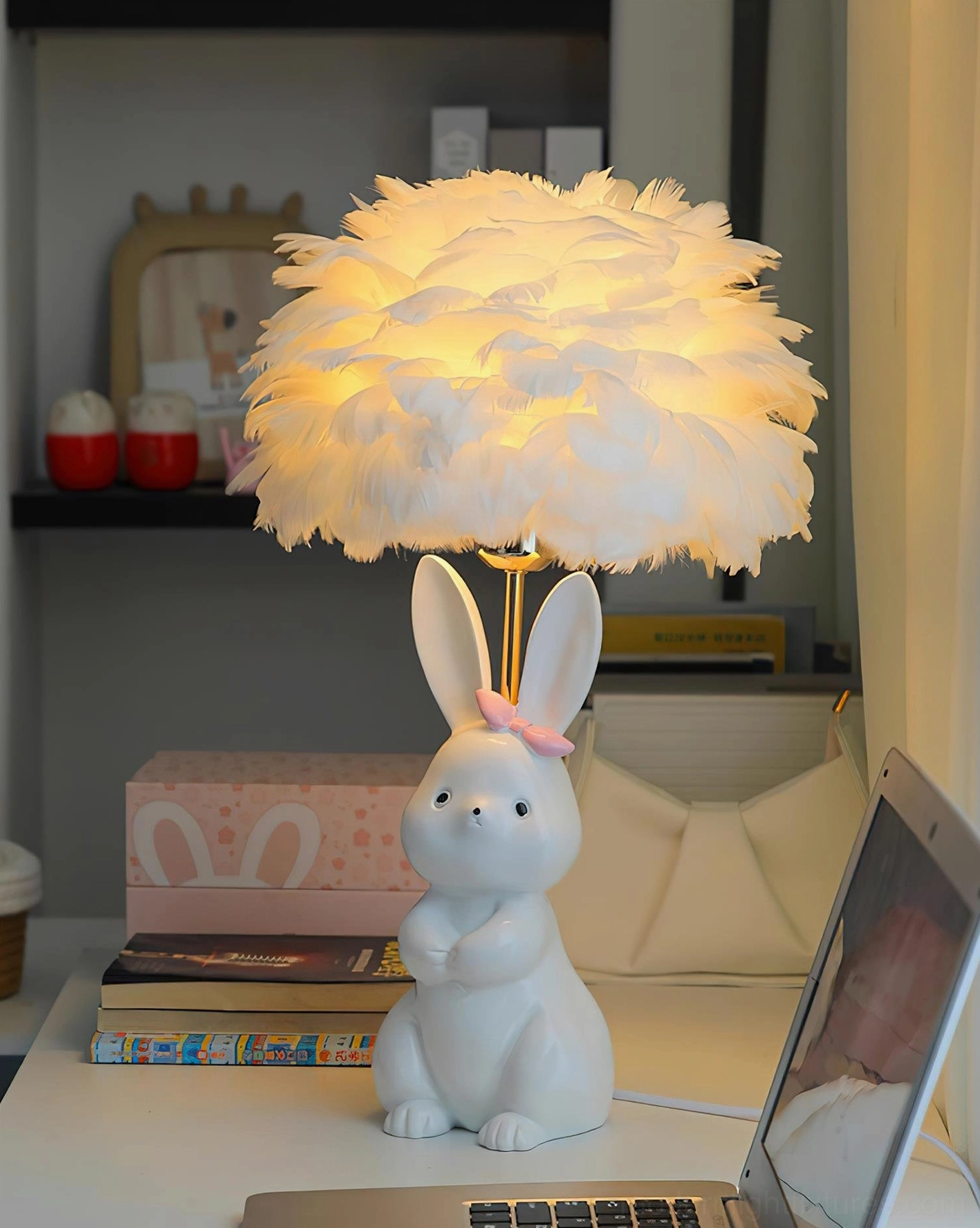 Illuminated pastel bunny ceramic lamp with warm feather shade on home desk with shelf - three-quarter view