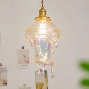 Lit water drop pendant light in indoor home setting - warm ambient lighting from LED bulb with wall décor backdrop