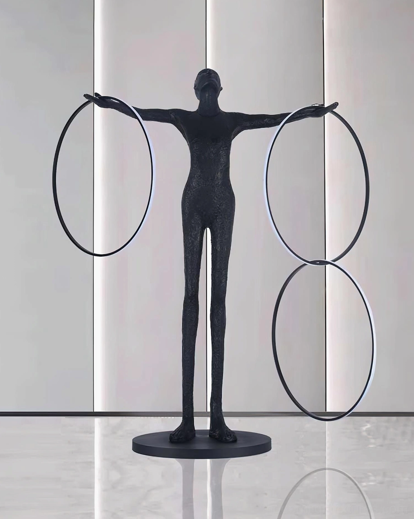 Liva sculpture lamp with three unlit geometric rings, matte black finish in minimalist glossy interior