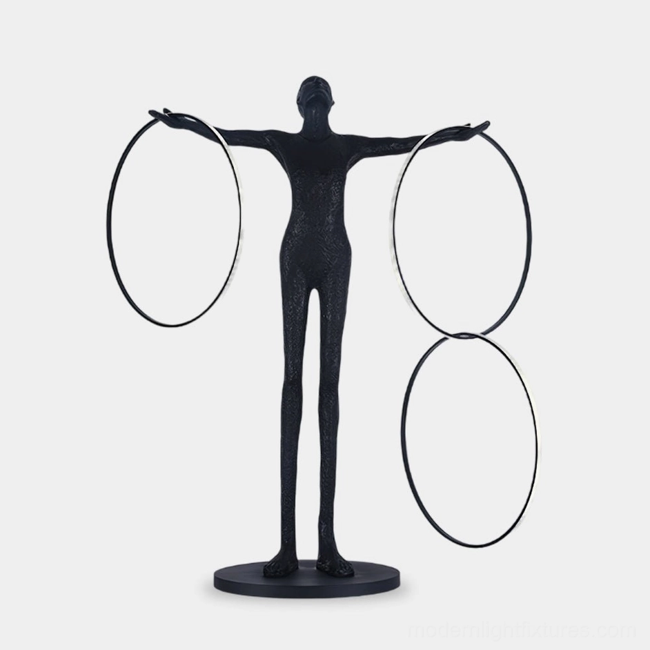 Liva Sculpture Floor Lamp front view with three geometric rings, matte black resin body on white studio background