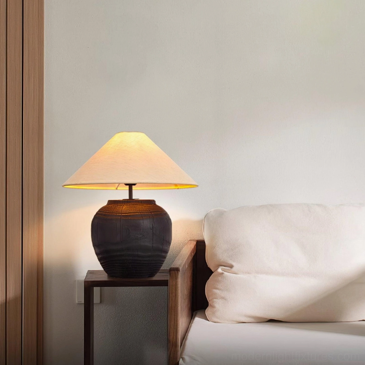 Textured resin table lamp beside linen sofa in contemporary living room
