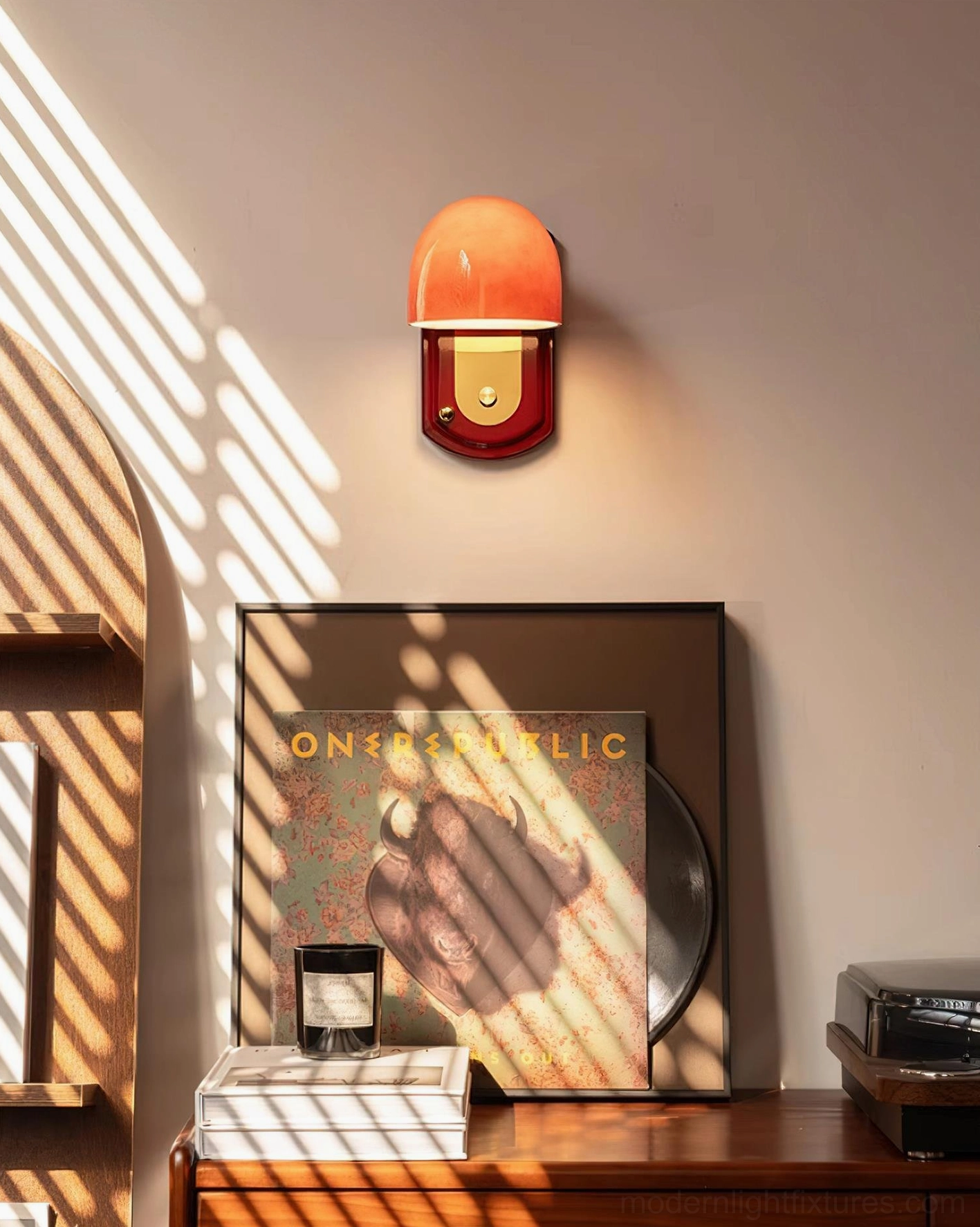 Lolita red wall sconce paired installation creating bilateral symmetry on neutral wall for gallery-like appearance