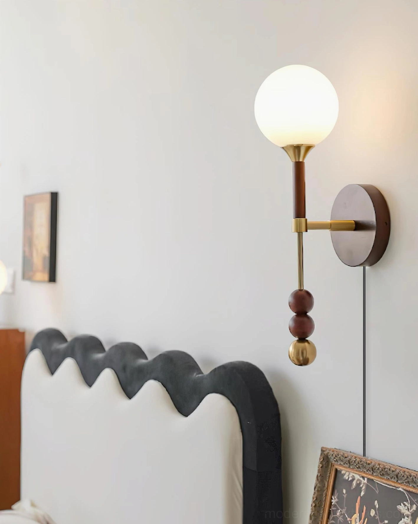 Lolli bedside wall sconce mounted beside upholstered scalloped headboard in contemporary bedroom