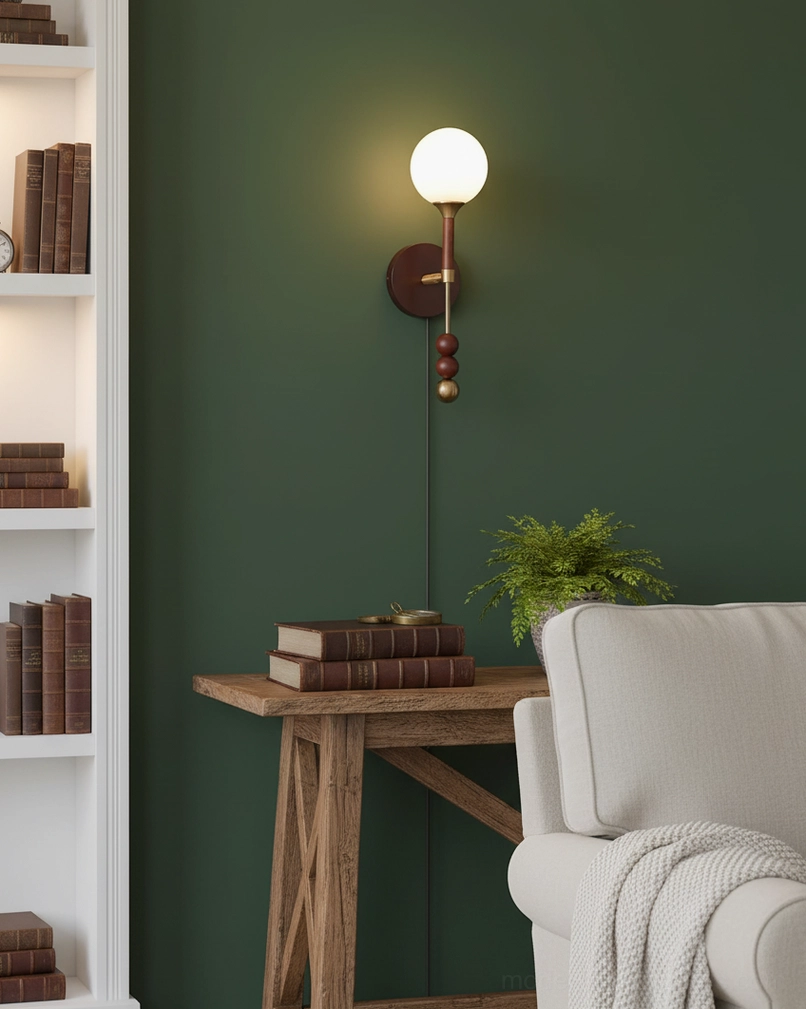 Lolli modern wall sconce in black with brass details in contemporary entryway with console table and mirror