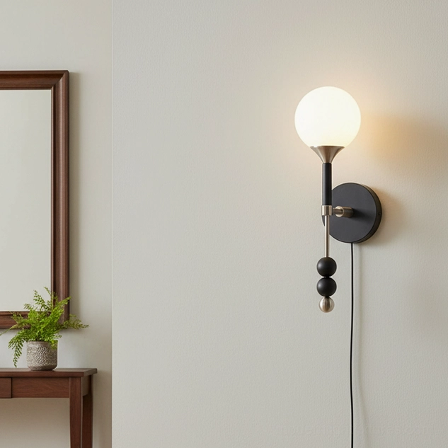 Lolli farmhouse style plug-in wall lamp with frosted glass shade above wooden side table in living room