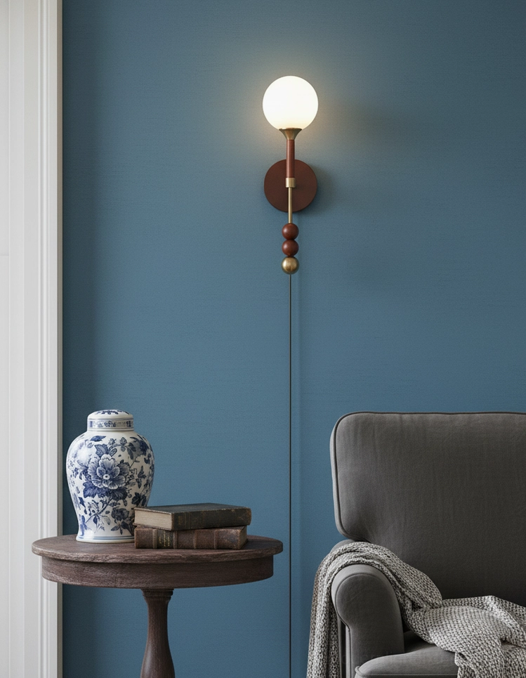 Lolli mid-century modern wall lamp with copper accents and natural wood body in stylized room setting