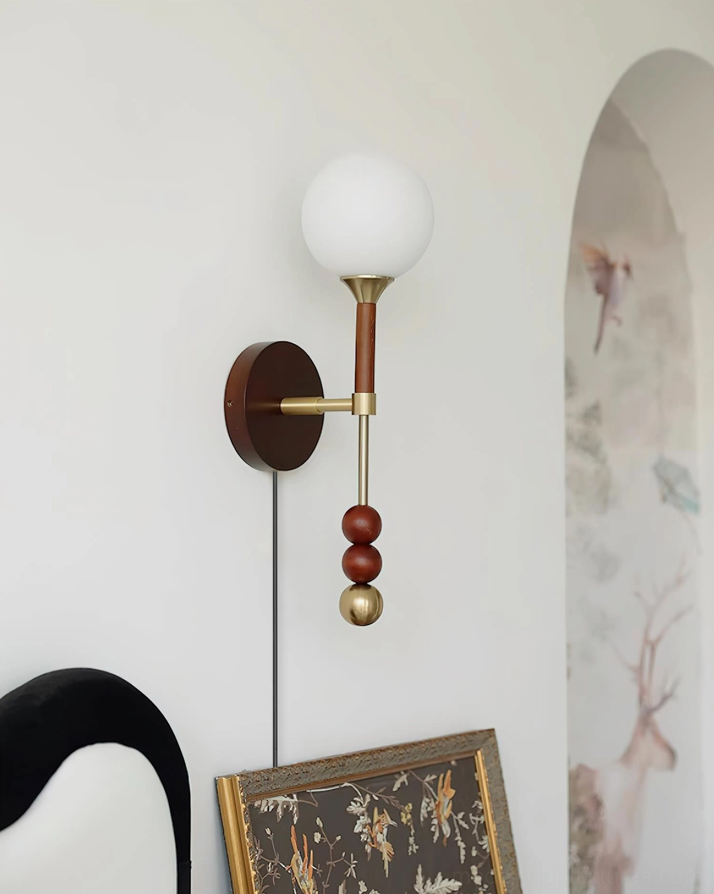 Lolli sculptural wall lamp with exposed power cord in hallway with arched wall decor details
