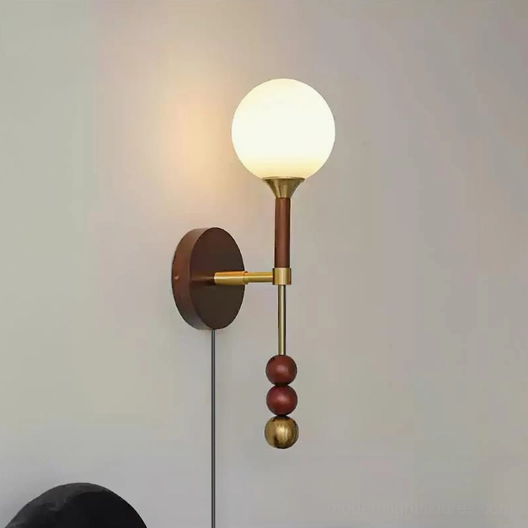 Lolli wall sconce in copper and walnut finish with warm metallic tones and wood base