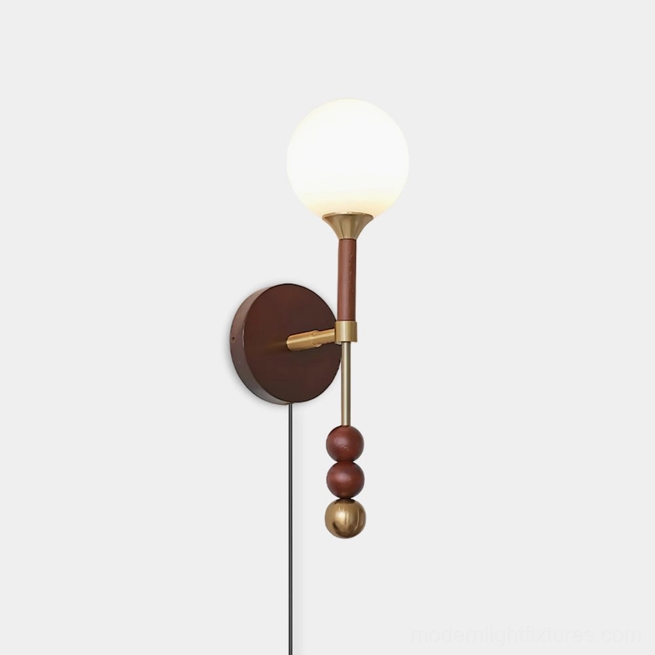 Lolli plug-in wall sconce with frosted glass orb and geometric metal spheres, front view on white background