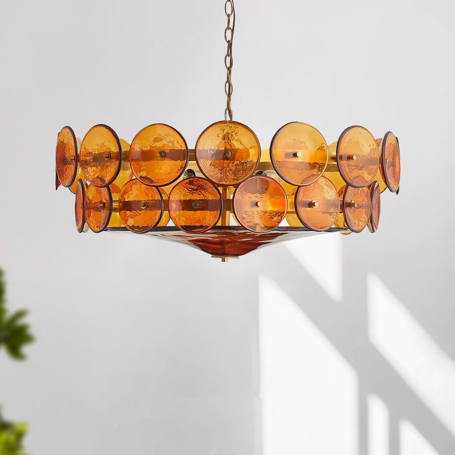 Lorenzo modern brass chandelier three-quarter overhead angle with crackled amber glass and chain