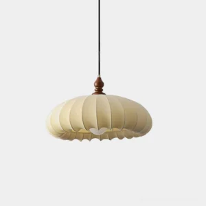 Lotus Belly pendant light with cream pleated fabric shade and dark walnut wood connector, front studio view showing pumpkin-shaped fabric design