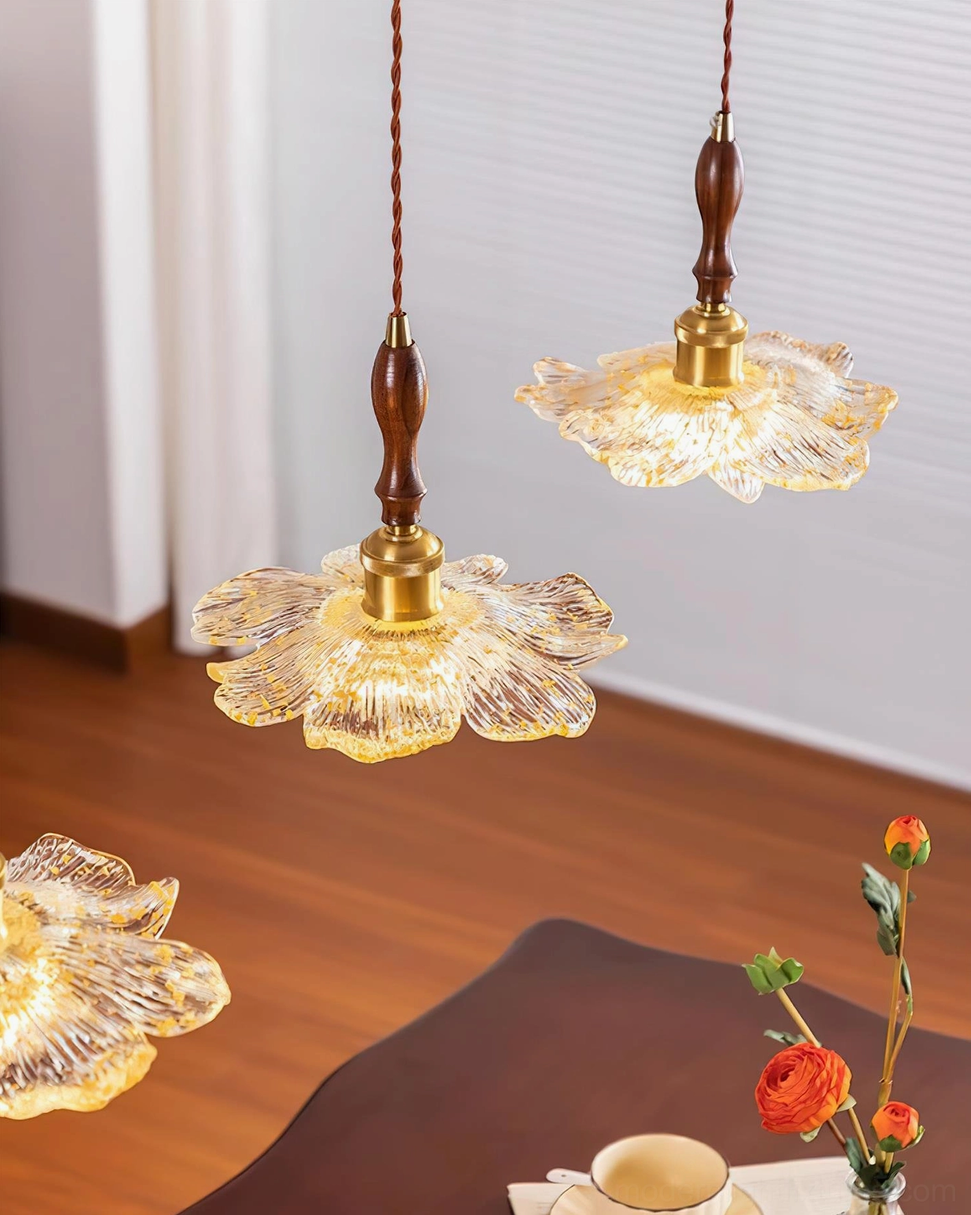 Multiple lotus pendant lights in dining area above wooden table with floor