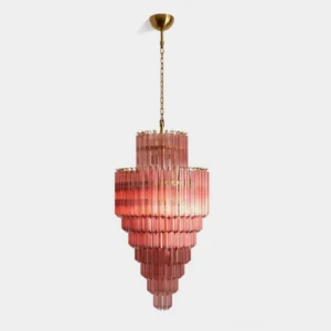 Lucerine tiered pink glass chandelier with antique brass frame and cascading ribbed glass rods on white background