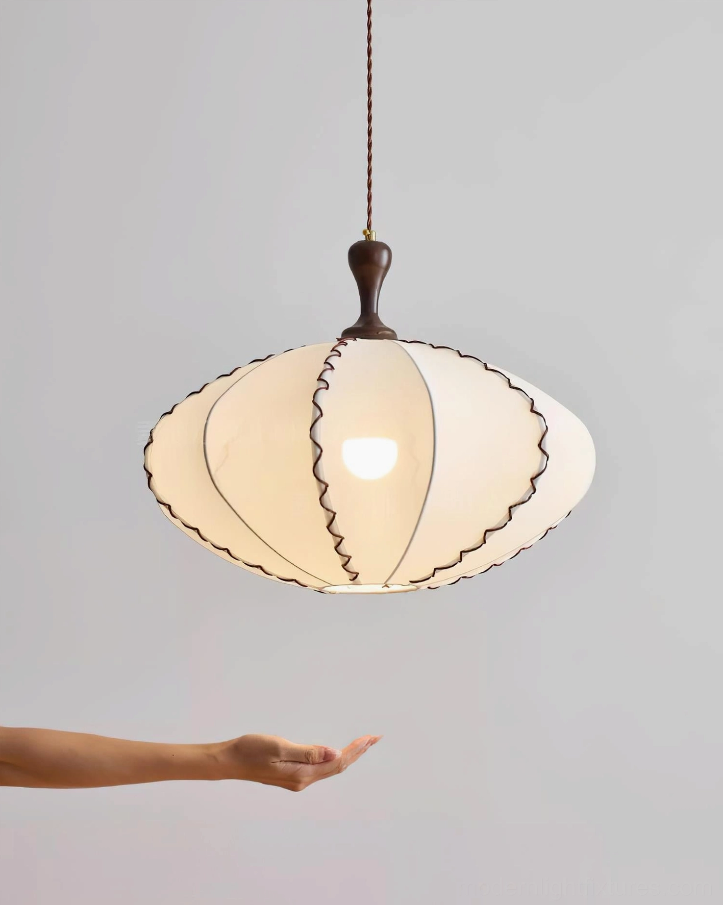 Lucian textile pendant light fixture showing fabric shade craftsmanship and walnut-tone wooden finial accent