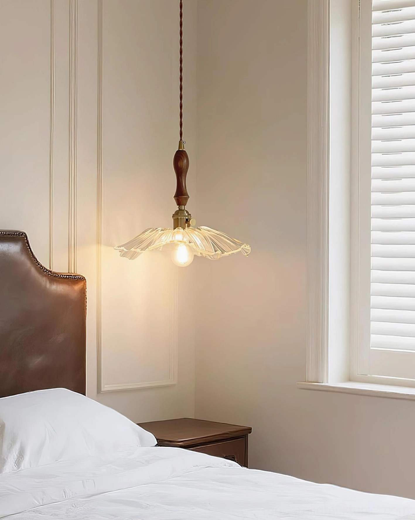 Clear translucent glass pendant lamp in bedroom with louvered windows, soft light diffusion, lotus design