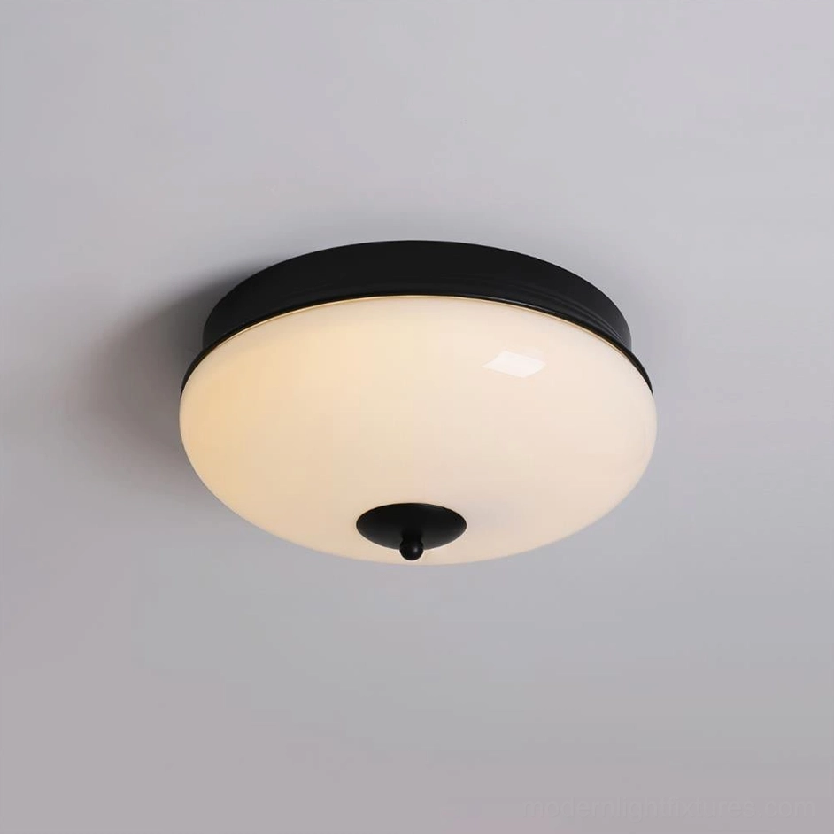 Matte black Ludo ceiling light mounted on gray indoor ceiling, overhead installation view