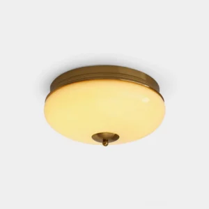 Ludo round flush mount ceiling light with warm brass finish and frosted glass shade, overhead front view