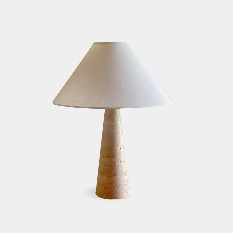 Lulu natural travertine table lamp with conical stone base and warm linen fabric shade, front studio view on white background