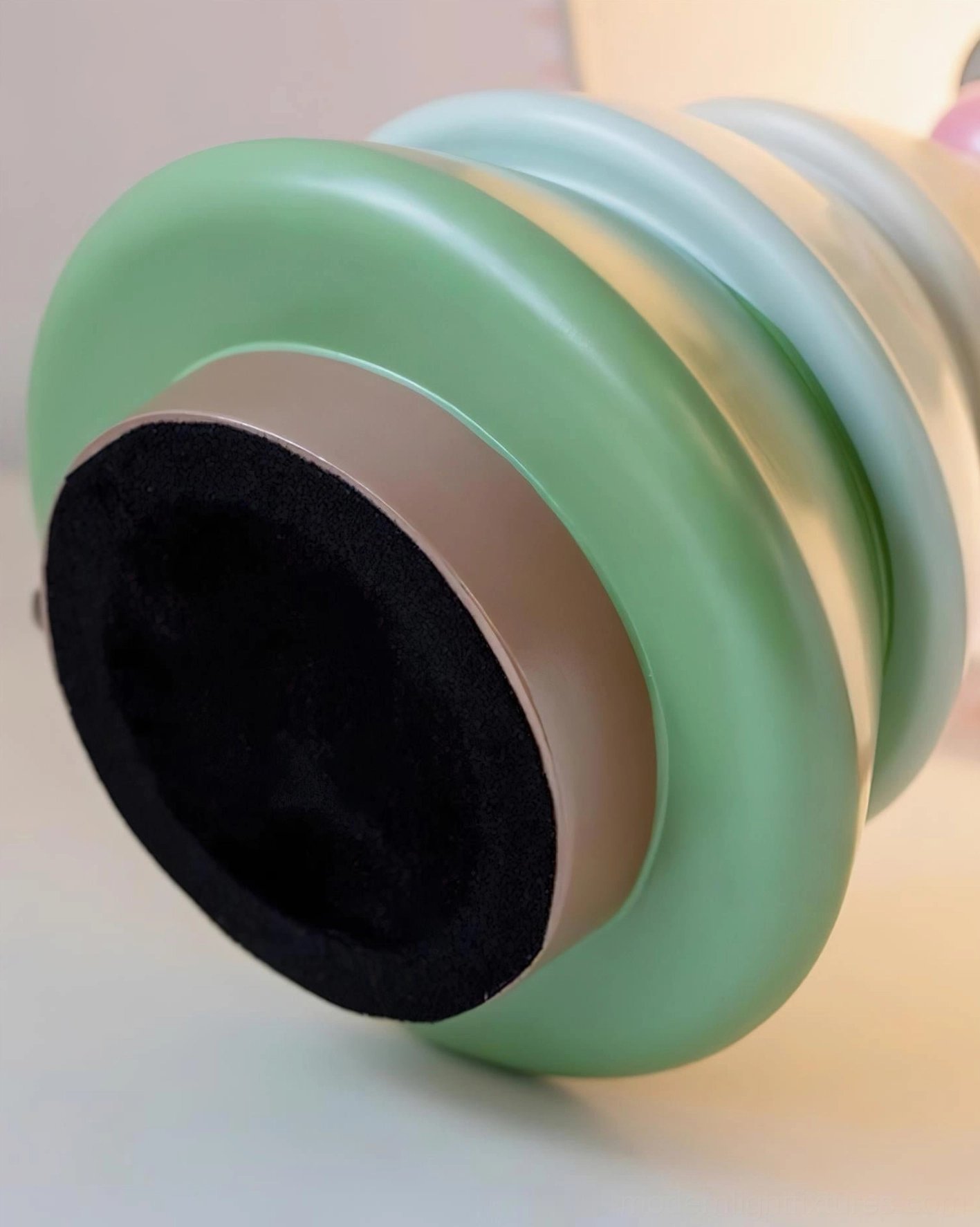 Luma Globe table lamp base bottom view showing anti-slip black foam pad and layered pastel resin structure